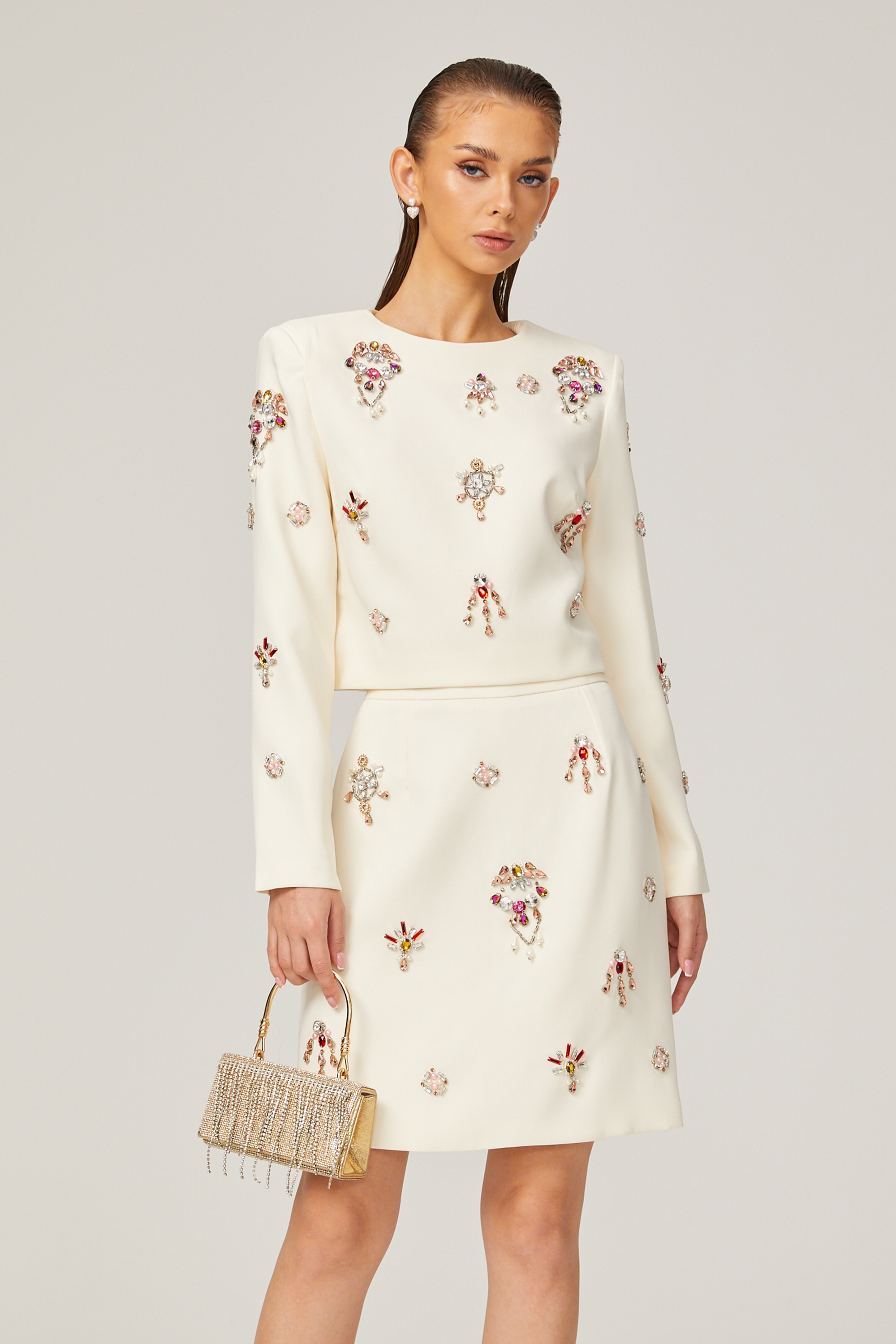 طقم Jeanne المكون من بلوزة وتنورة مزينة بالكريستال الأبيض