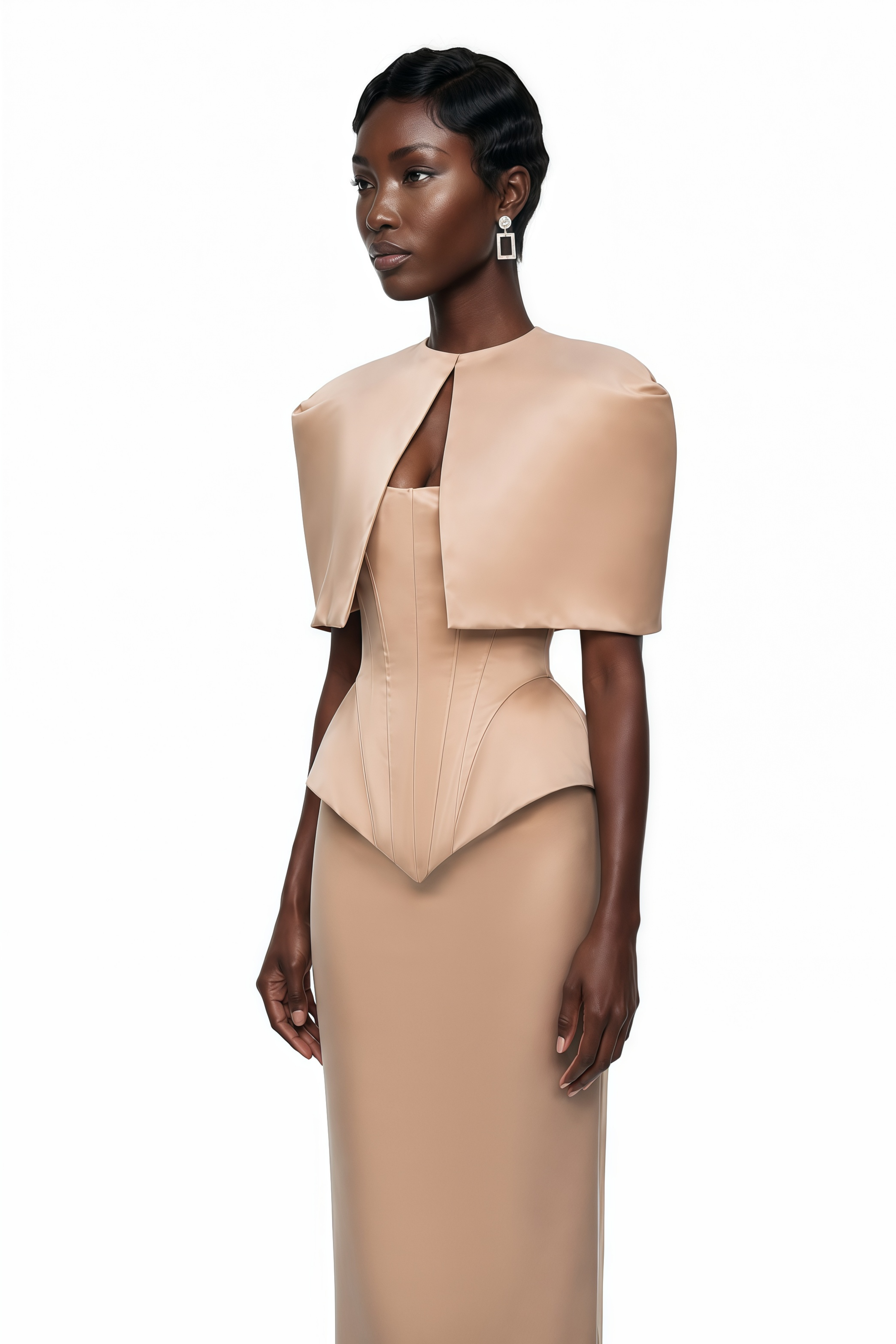 Nude beige satin mermaid gown featuring a structured corset bodice and a matching sculptural caped bolero