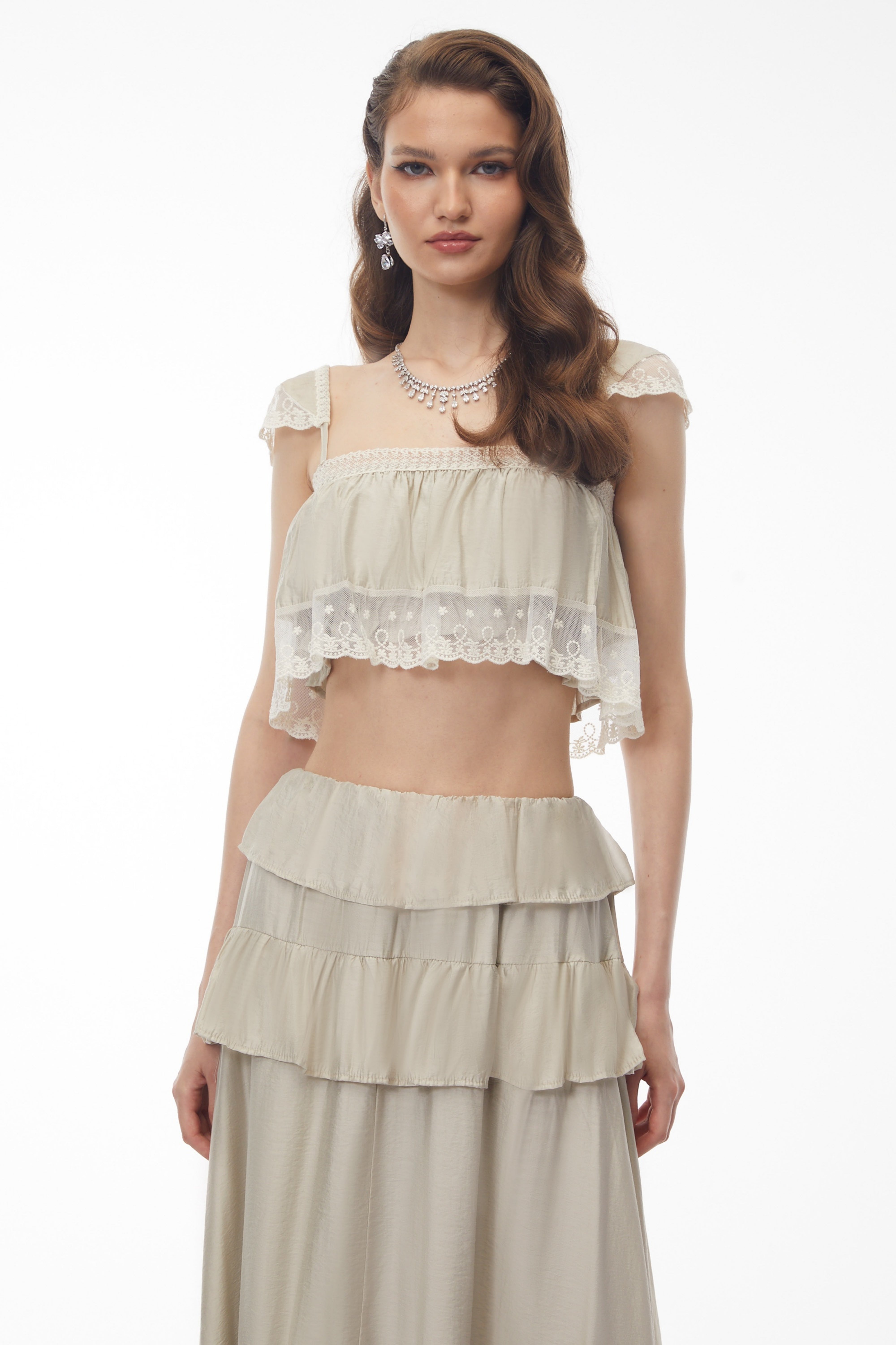 طقم من جوتورنا يتألف من بلوزة قصيرة باللون المشمشي الرمادي وتنورة مكشكشة