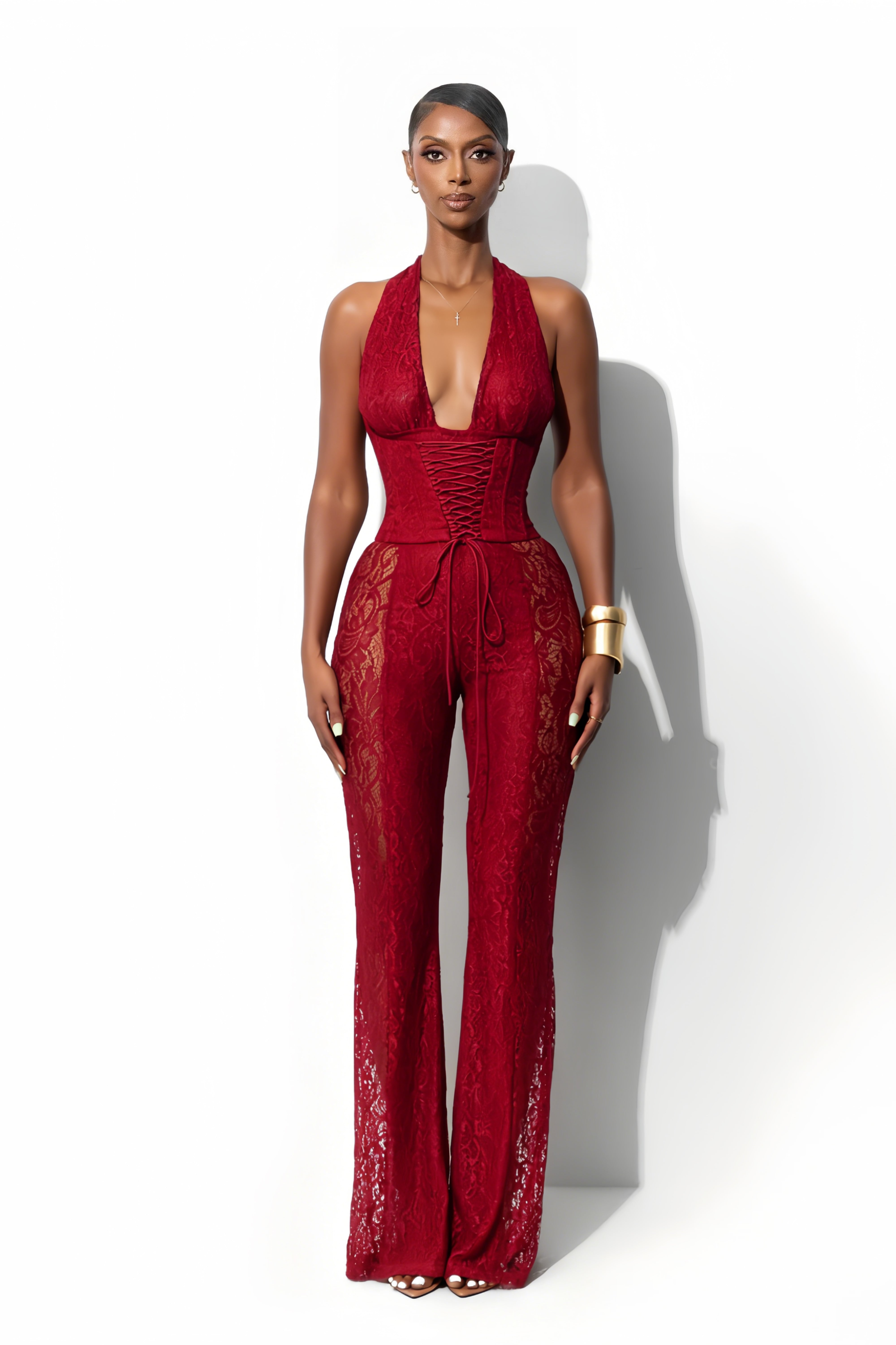 Lace halter jumpsuit with a corset-style lace-up bodice and flared legs