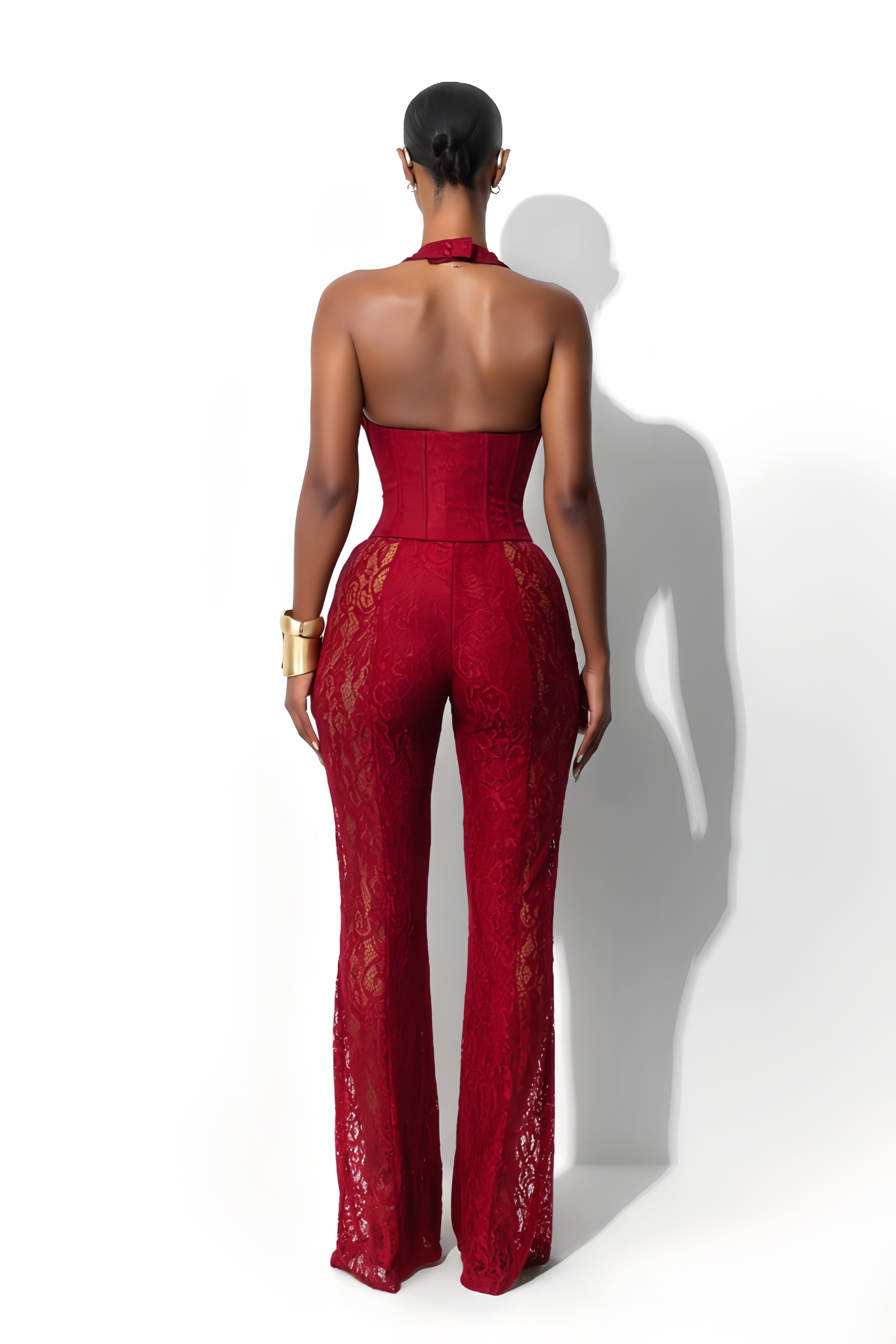 Lace halter jumpsuit with a corset-style lace-up bodice and flared legs