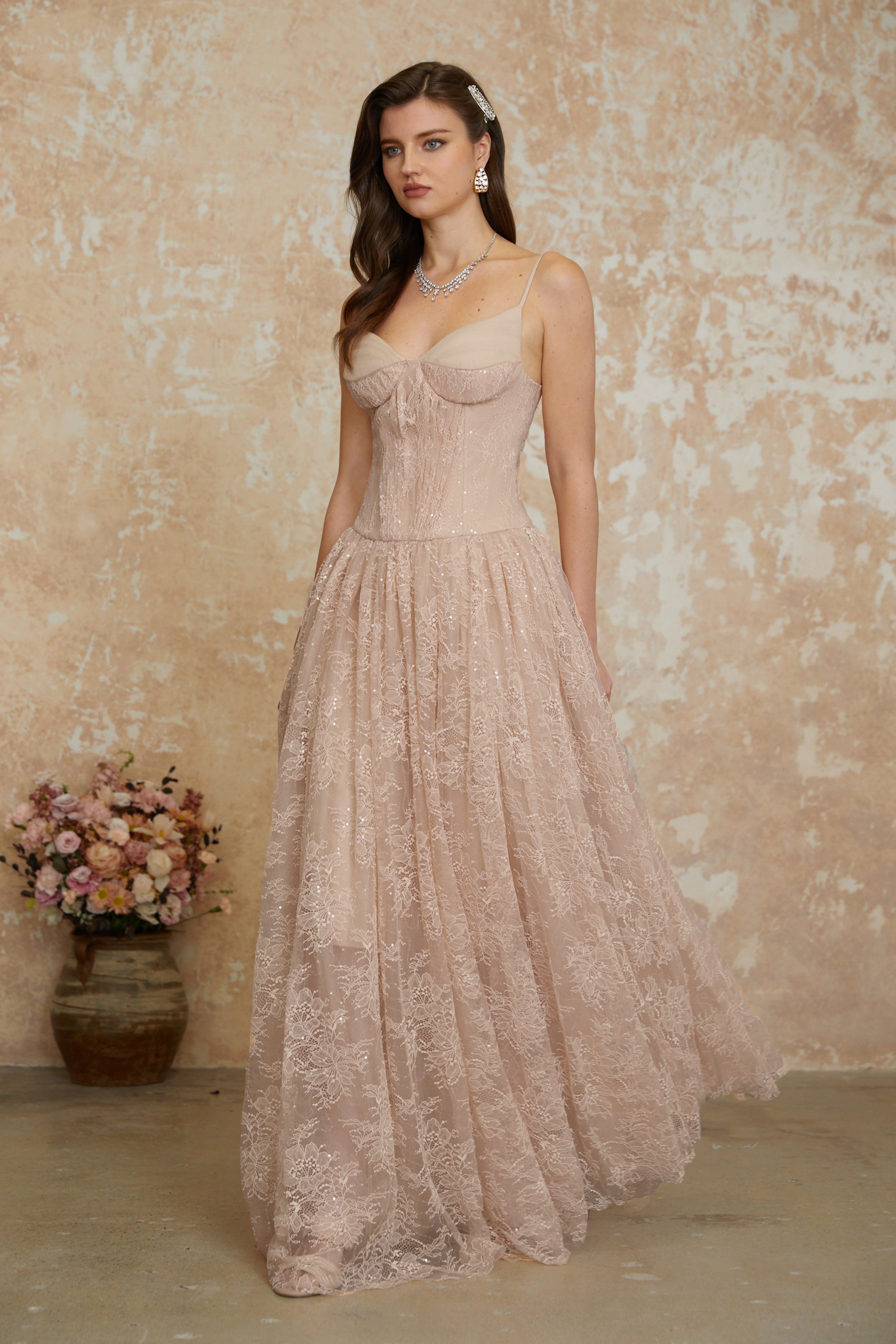 Blush pink sequined lace A-line gown with a structured corset bodice and thin shoulder straps