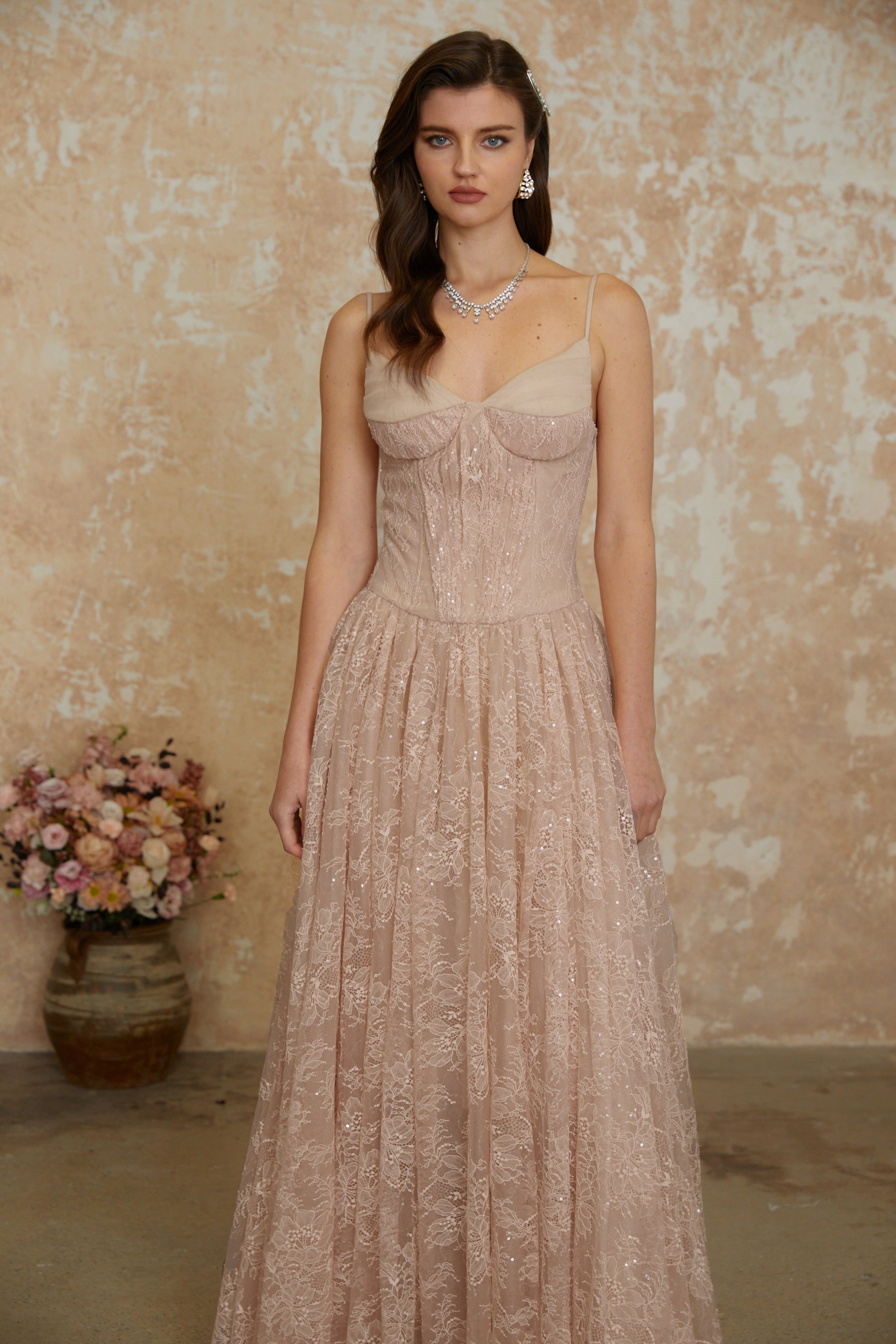 Blush pink sequined lace A-line gown with a structured corset bodice and thin shoulder straps