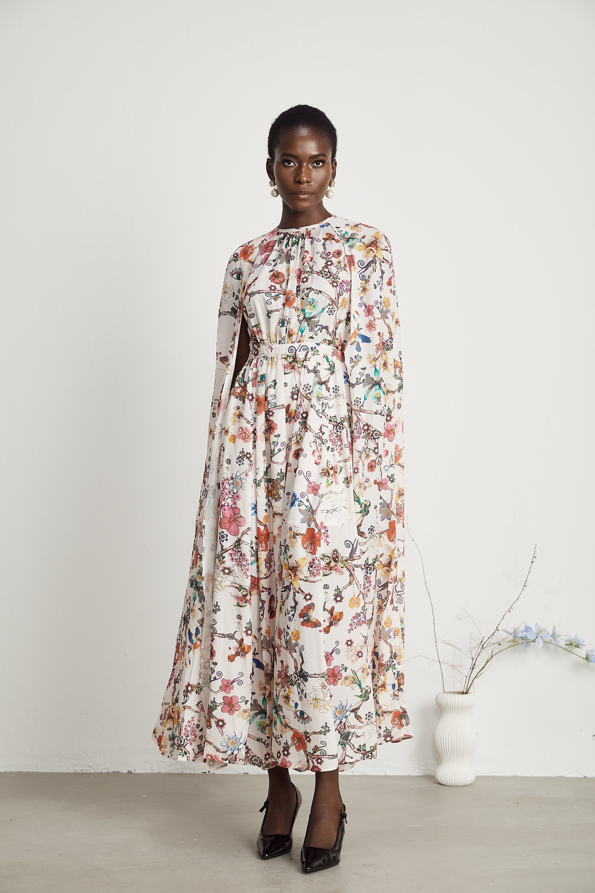 Elara floral-print cape-design maxi dress