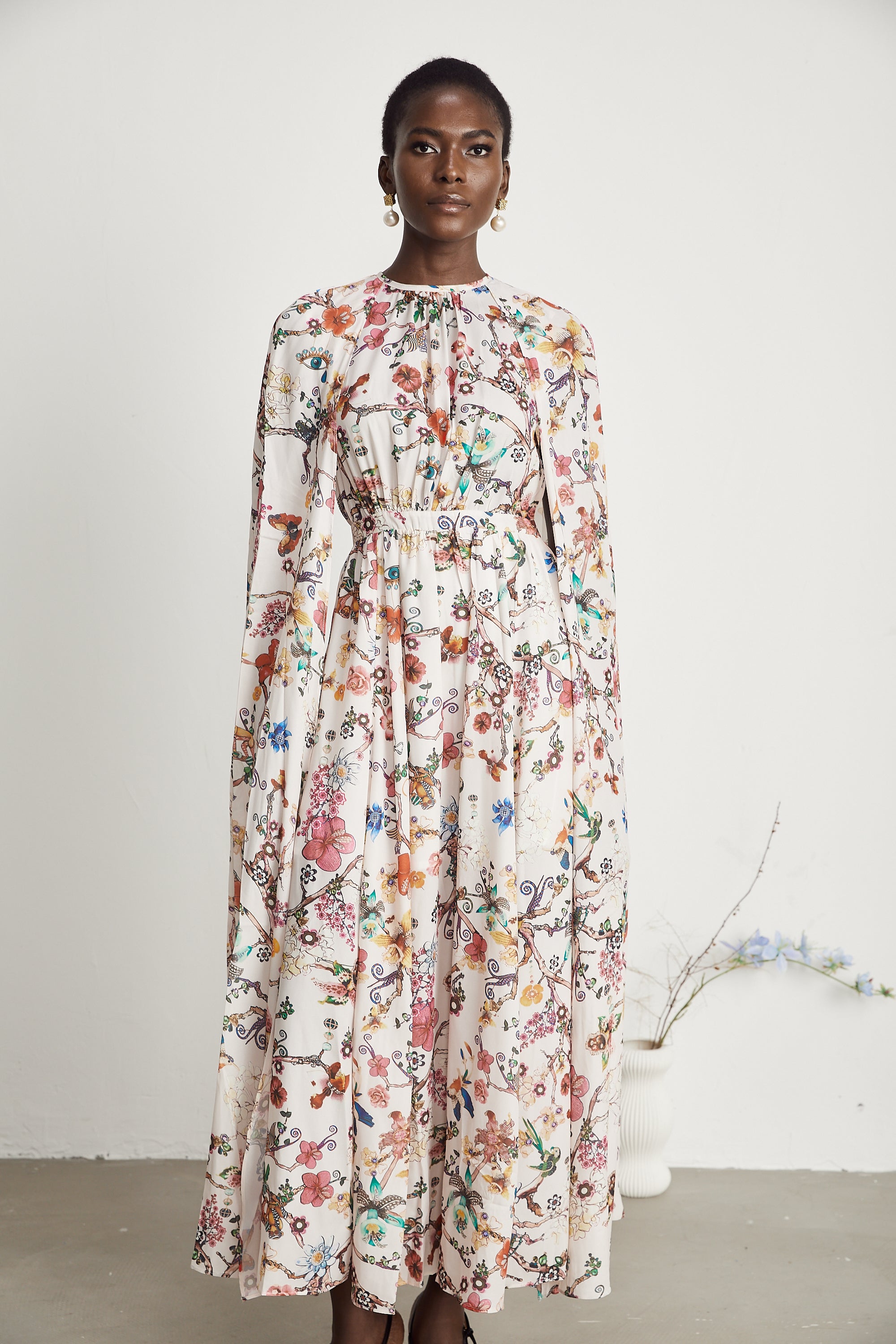 Elara floral-print cape-design maxi dress