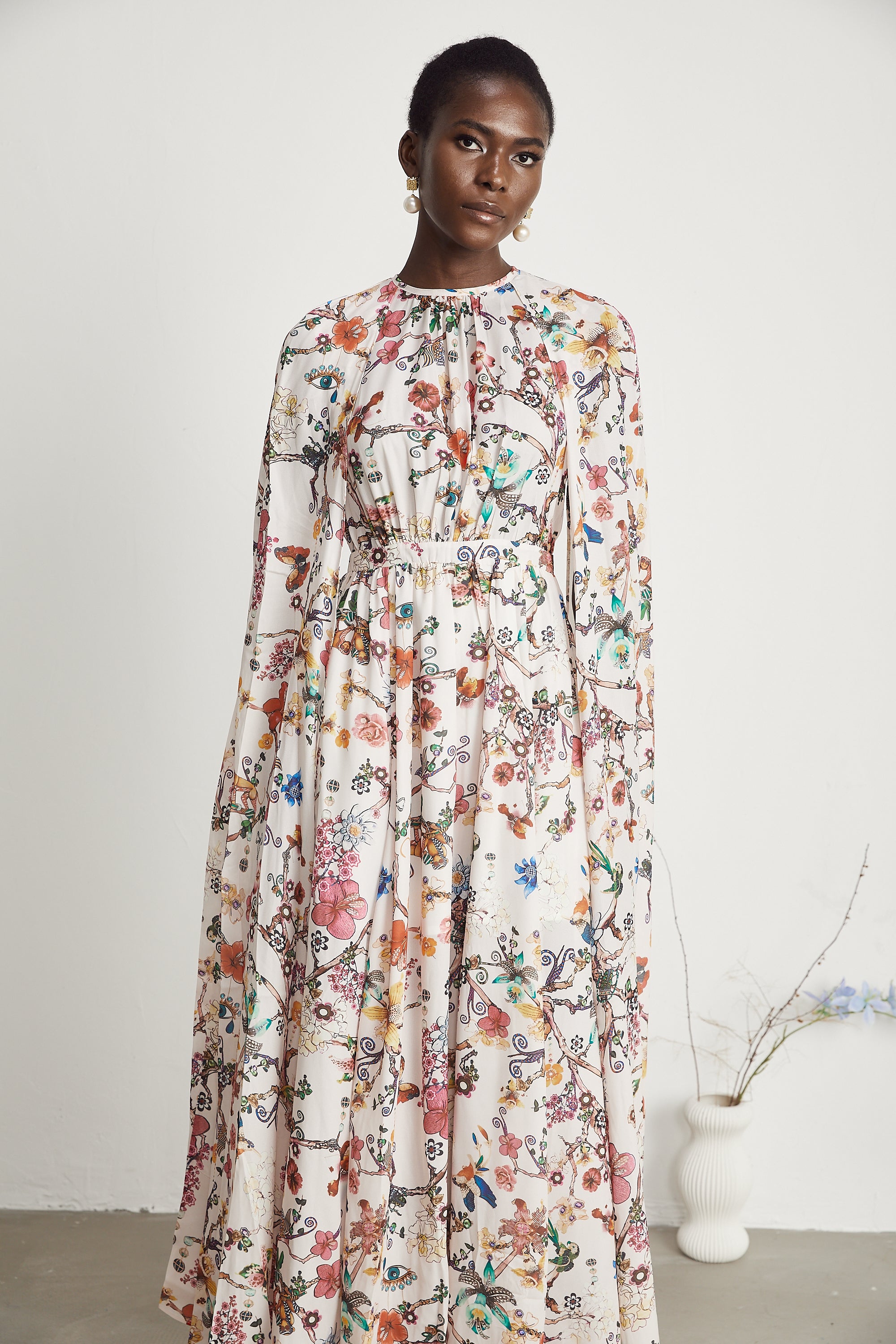 Elara floral-print cape-design maxi dress