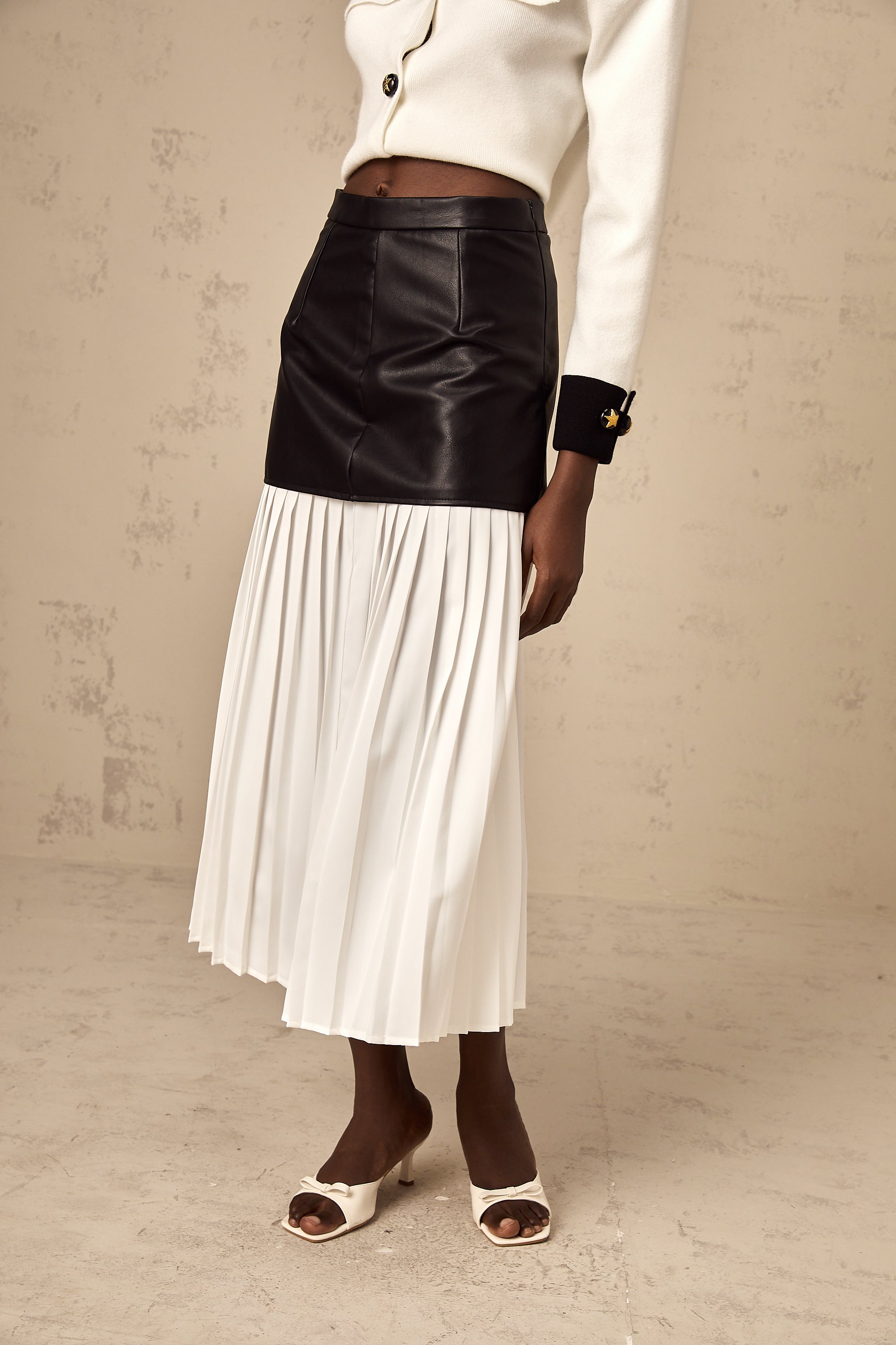 Aria color-blocked panelled pleated midi skirt