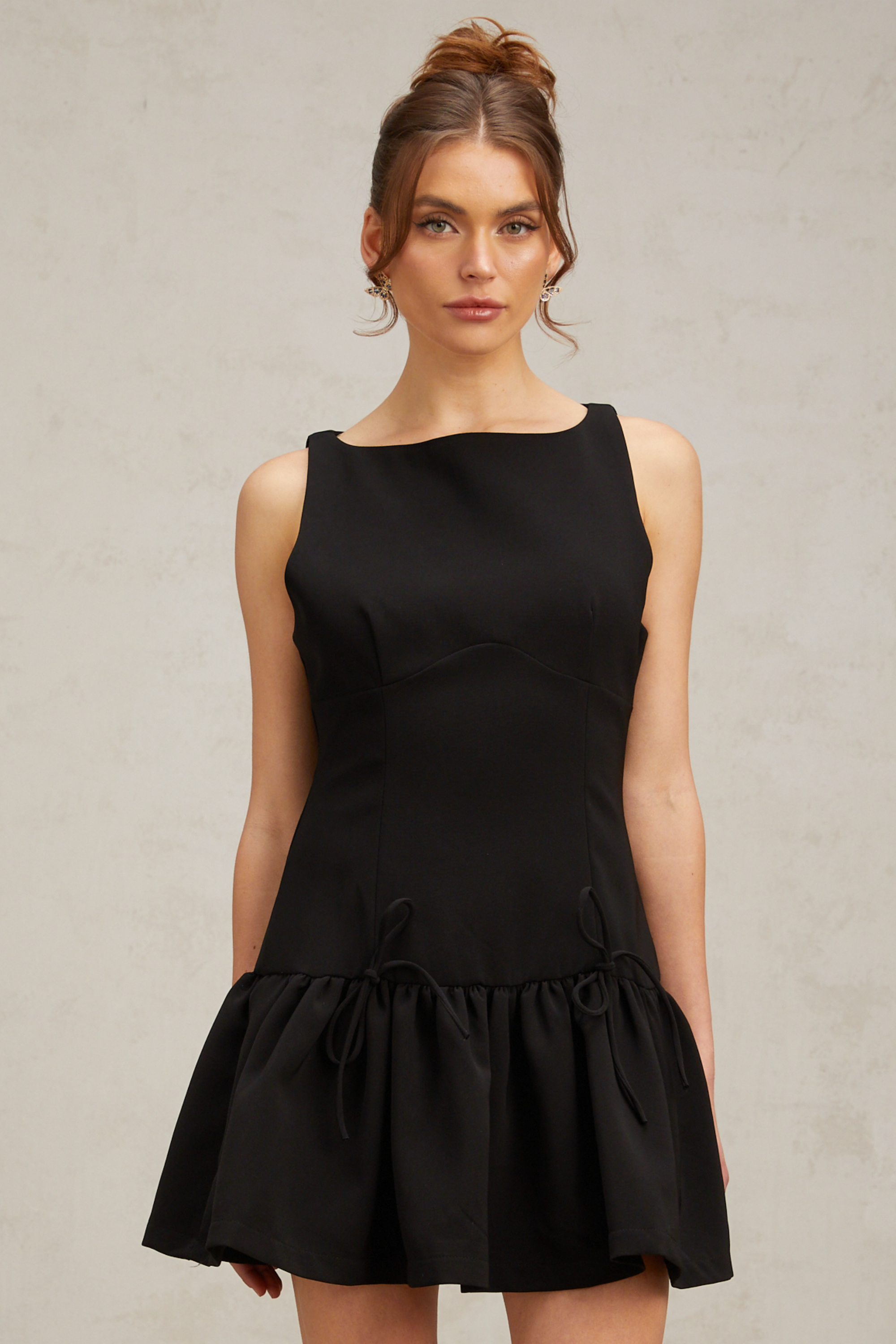 Emilia black bow-embellished pleated mini dress