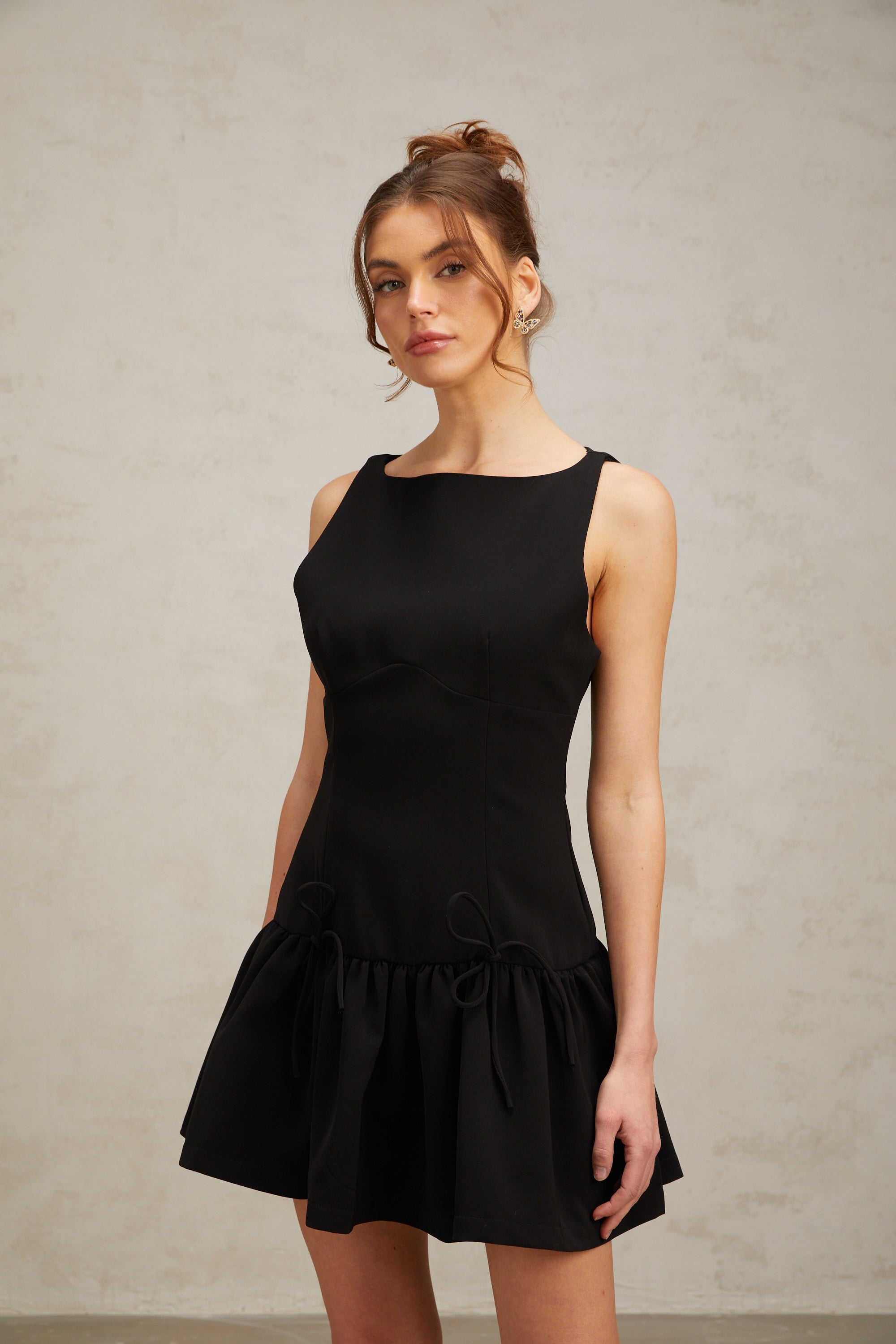 Emilia black bow-embellished pleated mini dress