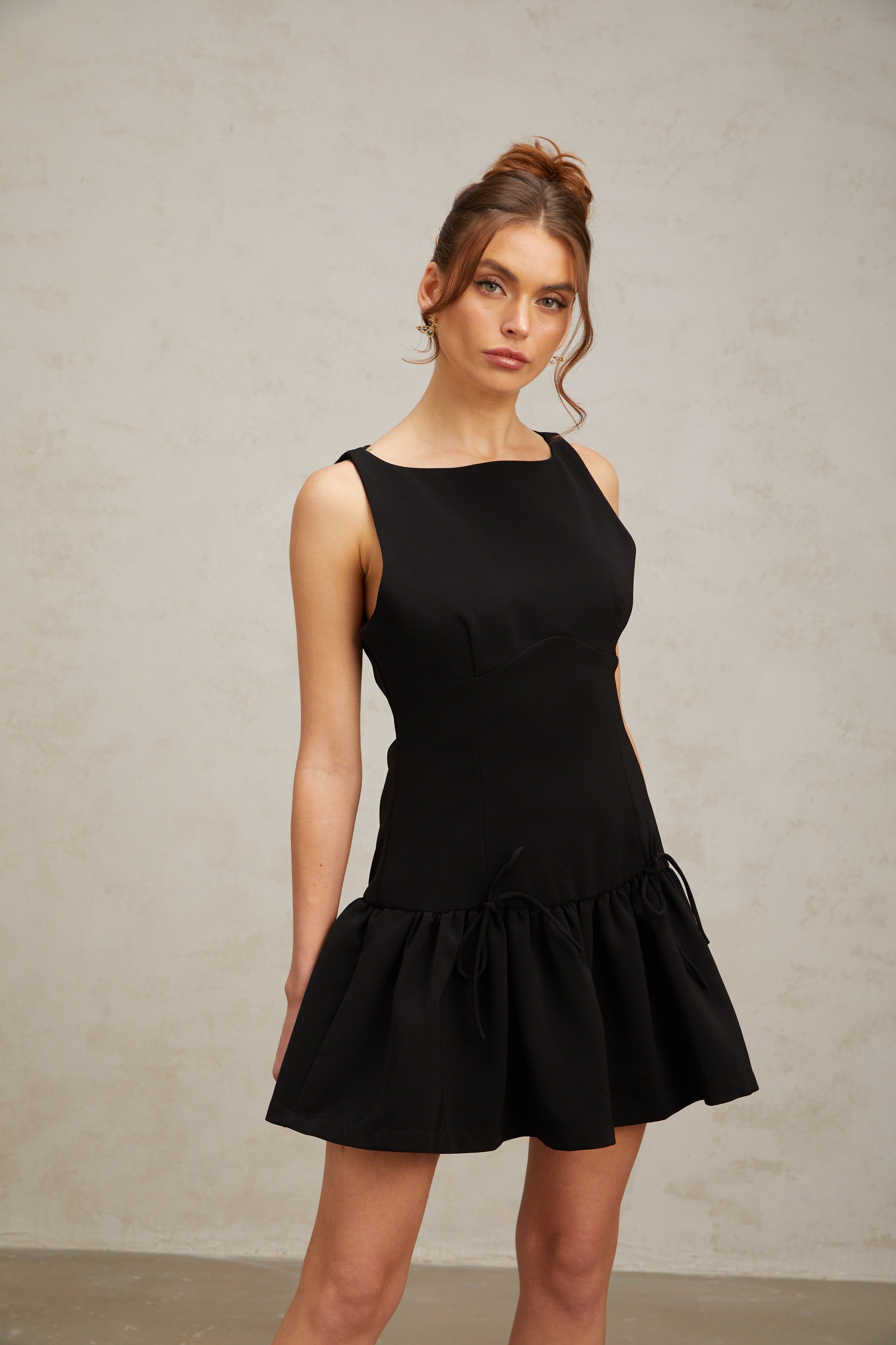 Emilia black bow-embellished pleated mini dress