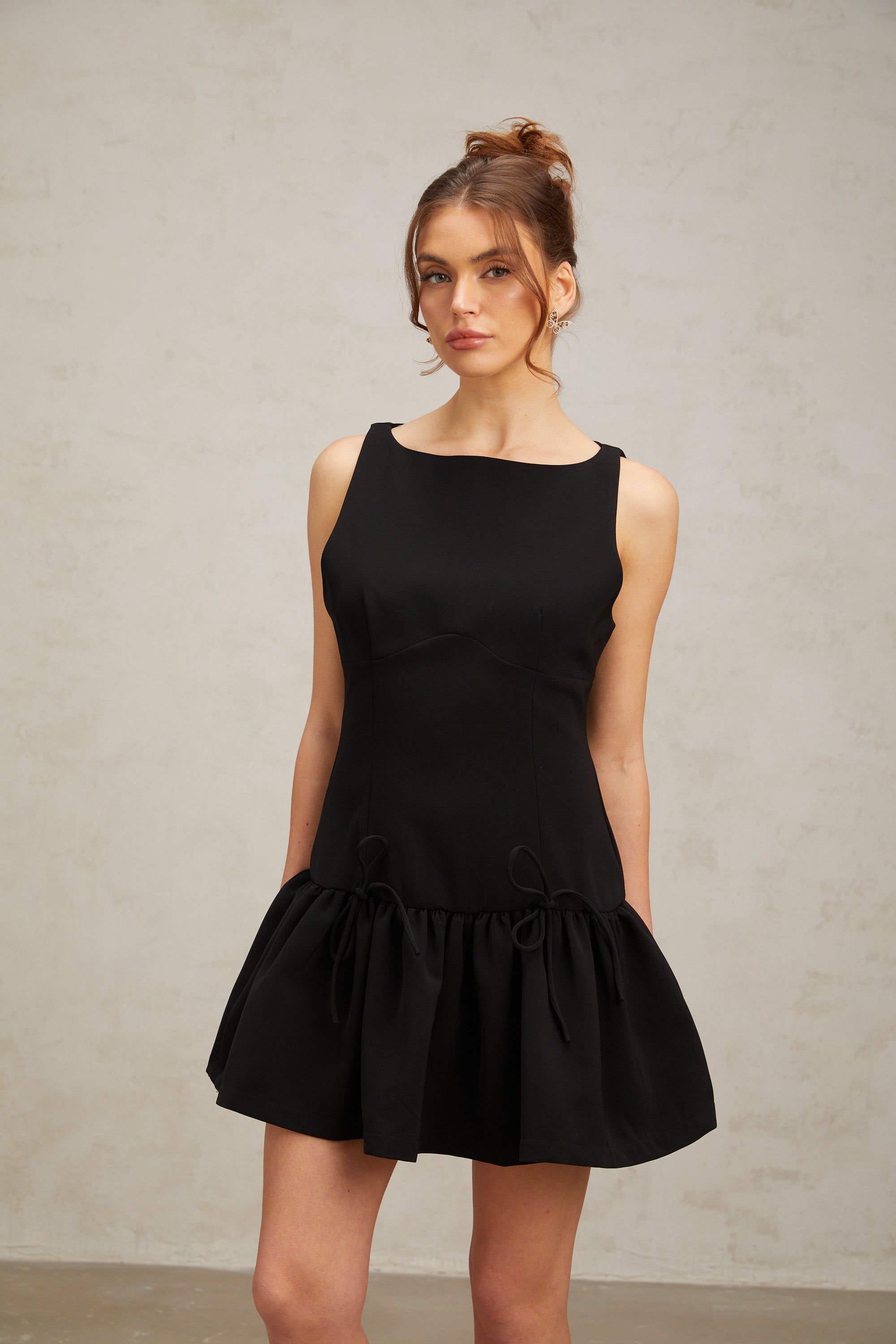 Emilia black bow-embellished pleated mini dress