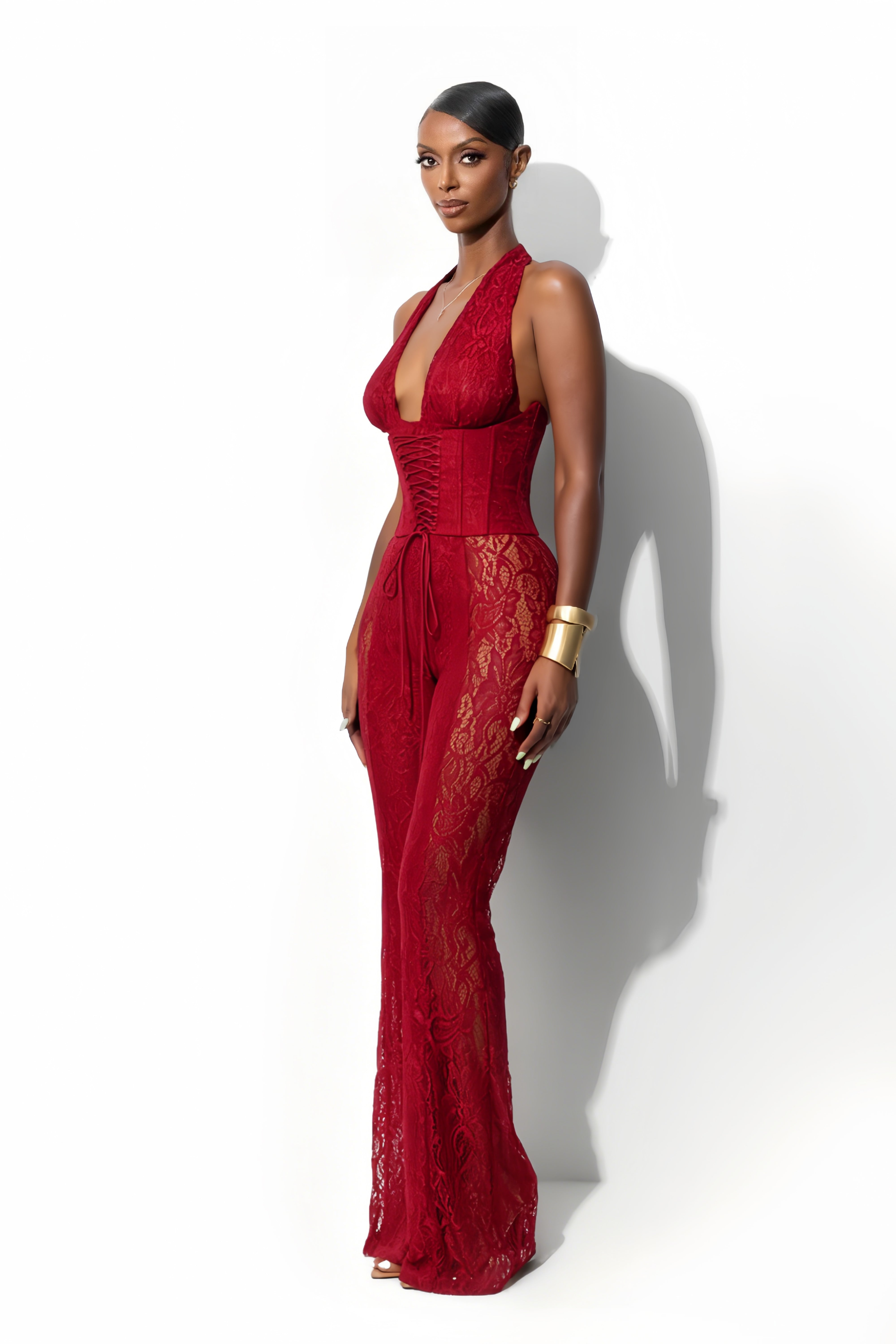 Lace halter jumpsuit with a corset-style lace-up bodice and flared legs