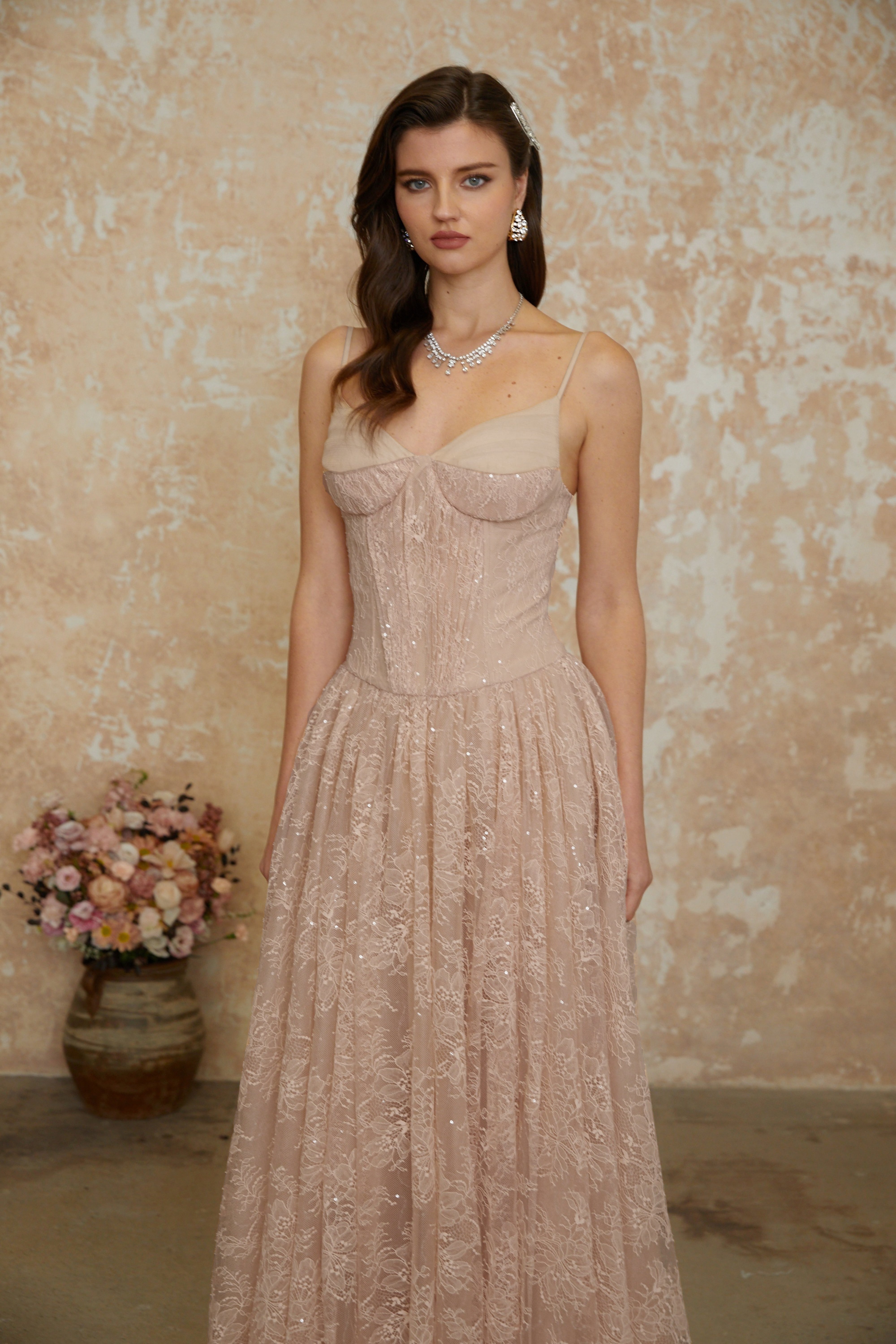 Blush pink sequined lace A-line gown with a structured corset bodice and thin shoulder straps