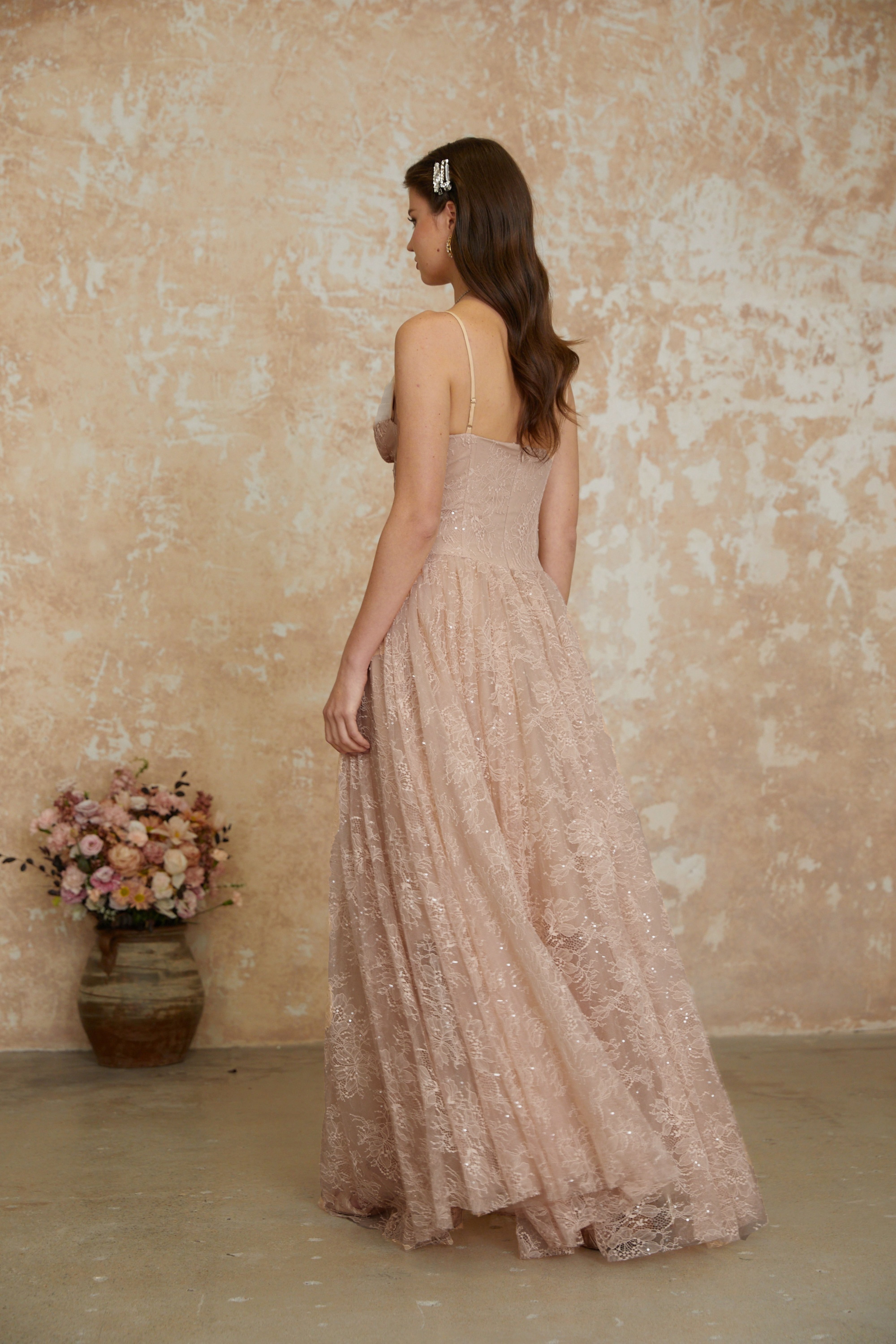 Blush pink sequined lace A-line gown with a structured corset bodice and thin shoulder straps